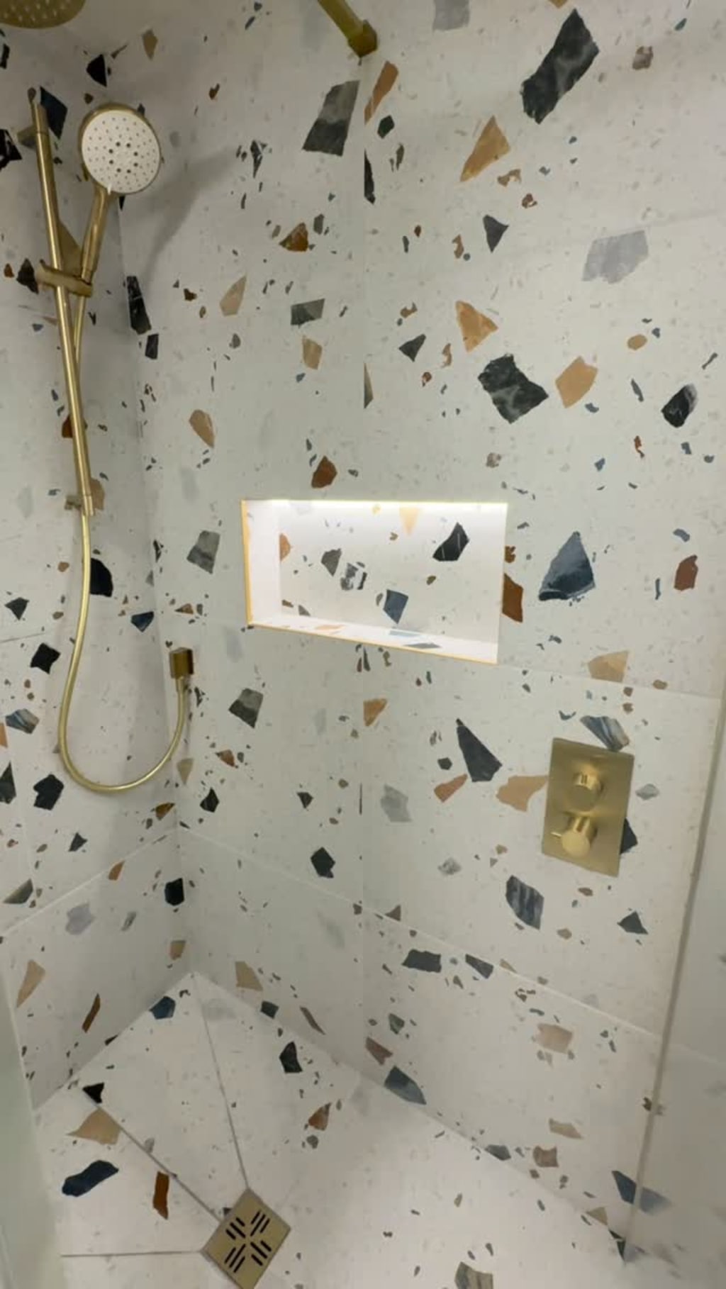 From basic to bold bathroom just completed in Upper Rissington near Bourton on the Water

This dated family bathroom was completely reimagined  in collaboration with the clients into a contemporary wet room with @boutiquestoneofficial terrazzo-effect porcelain tiles, brushed brass fittings from @drench.co.uk , tiled niche with lighting, a large recessed mirror & a fluted glass shower screen. The homeowner is delighted with the outcome 

#BathroomRenovation
#BathroomDesign
#BathroomInspo
#BeforeAndAfter
#BathroomTransformation
#BathroomGoals
#InteriorInspo
#LuxuryBathroom
#CotswoldBathroom
#Cirencester
#CirencesterLife
#CotswoldsLiving
#CotswoldBuilder
#CirencesterBuilder
#CotswoldHomes
#CotswoldRenovation
#TradesReel
#OnSiteToday
#SiteProgress
#QualityBuild
#SatisfyingTransformation
#HowItsMade
#ProgressReel
#ReelBuilds
#TimelapseTransformation
#RenovationReel
#CustomInteriors
#wetroomshower 
#wetroominstallation