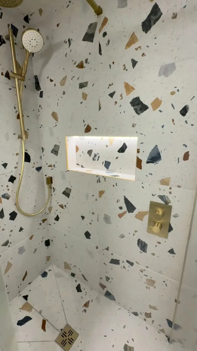 From basic to bold bathroom just completed in Upper Rissington near Bourton on the Water

This dated family bathroom was completely reimagined  in collaboration with the clients into a contemporary wet room with @boutiquestoneofficial terrazzo-effect porcelain tiles, brushed brass fittings from @drench.co.uk , tiled niche with lighting, a large recessed mirror & a fluted glass shower screen. The homeowner is delighted with the outcome 

#BathroomRenovation
#BathroomDesign
#BathroomInspo
#BeforeAndAfter
#BathroomTransformation
#BathroomGoals
#InteriorInspo
#LuxuryBathroom
#CotswoldBathroom
#Cirencester
#CirencesterLife
#CotswoldsLiving
#CotswoldBuilder
#CirencesterBuilder
#CotswoldHomes
#CotswoldRenovation
#TradesReel
#OnSiteToday
#SiteProgress
#QualityBuild
#SatisfyingTransformation
#HowItsMade
#ProgressReel
#ReelBuilds
#TimelapseTransformation
#RenovationReel
#CustomInteriors
#wetroomshower 
#wetroominstallation